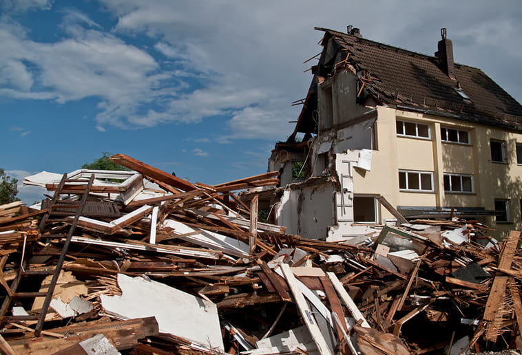 Storm damaged roof and exterior awaiting repair